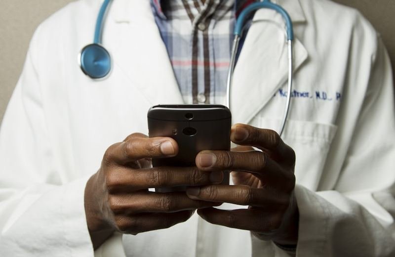 A clinician in a white coat with a stethoscope